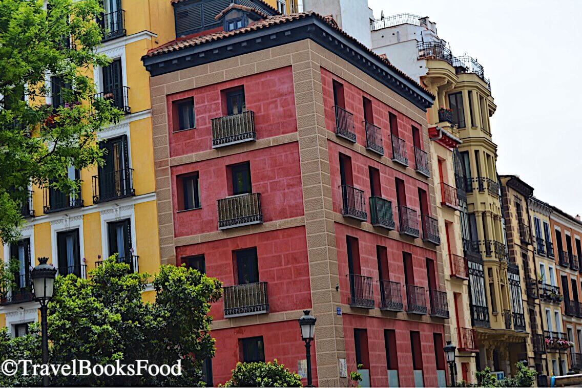 Madrid is full of colorful buildings and this is a photo of a pink, yellow and other buildings