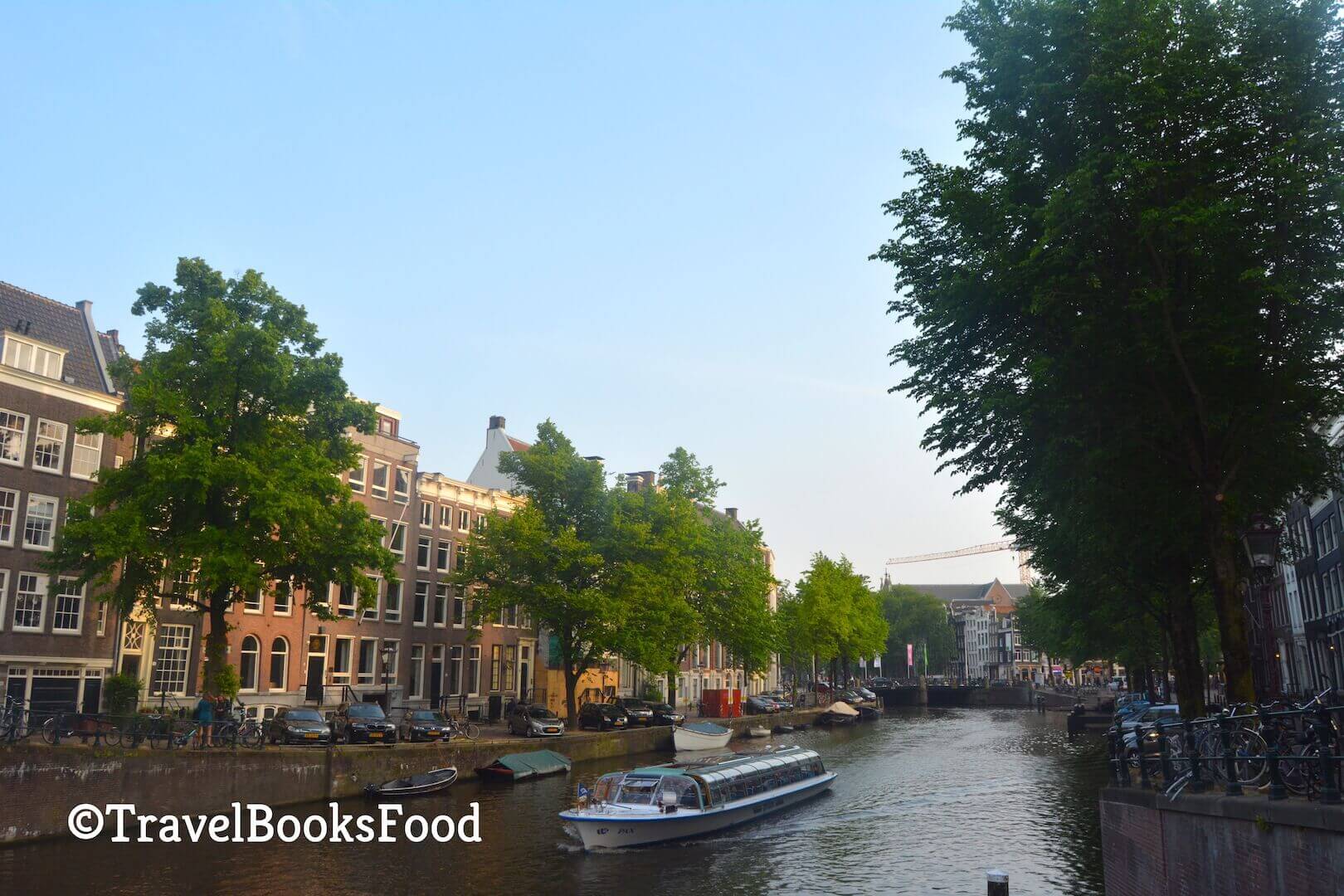 A photo of the famous Amsterdam canals with houses and trees on both sides