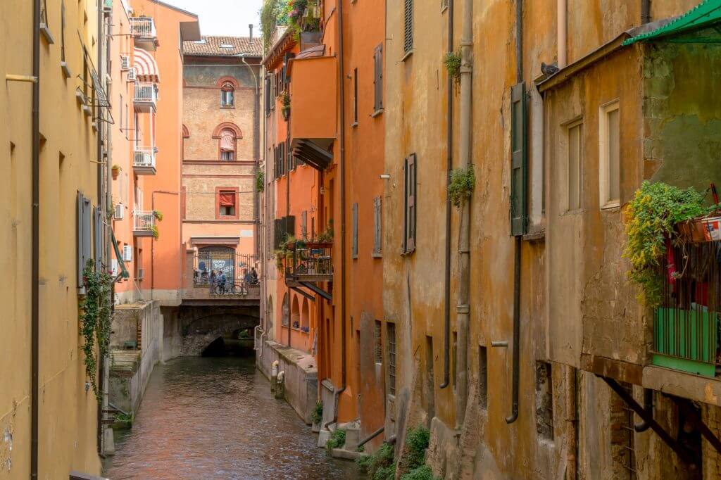 A photo of a street with colourful buildings in Bologna, Italy