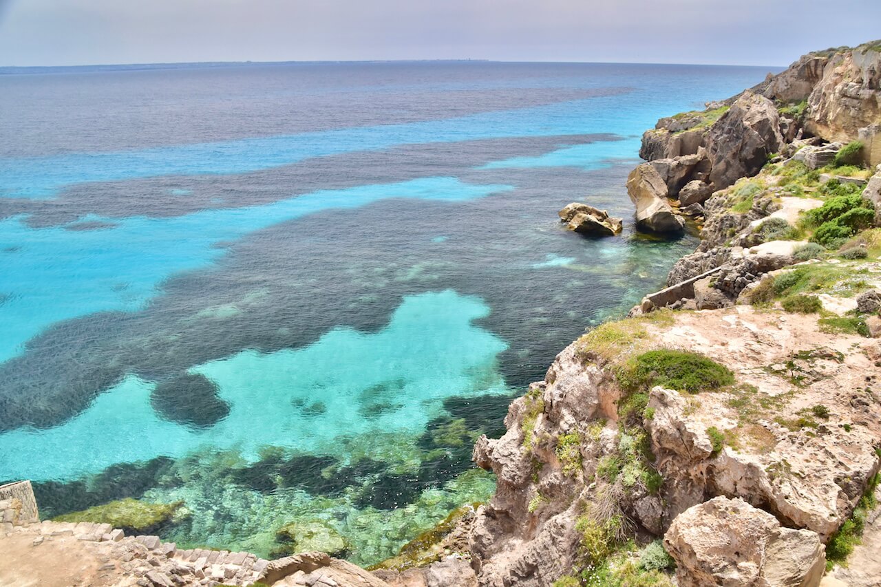 A photo of some cliffs overlooking a green sea