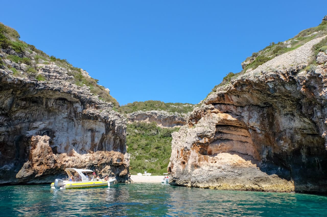 In this photo, you can see two cliffs surrounded by green-blue water