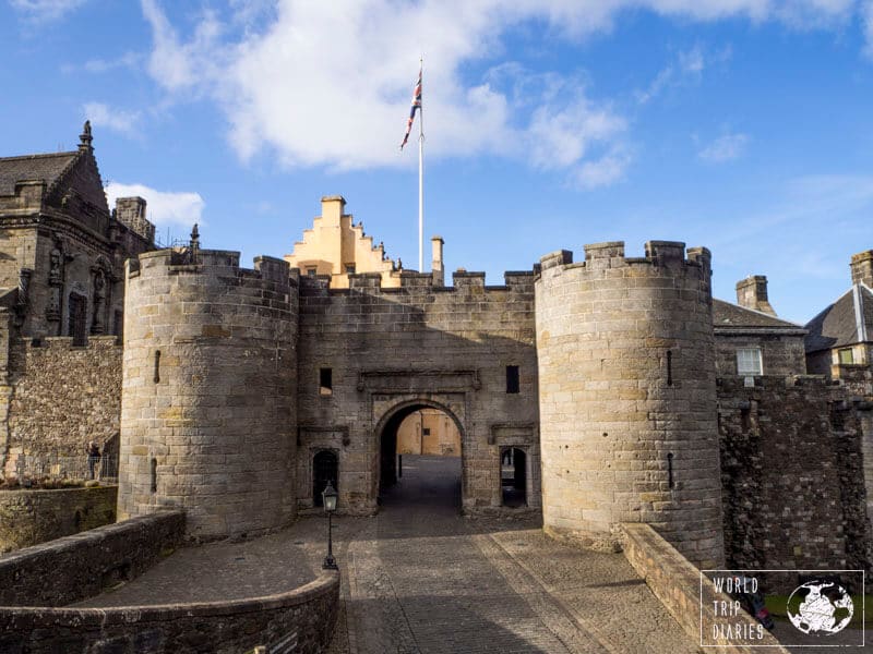 A picture of a stone castle with a flag in front