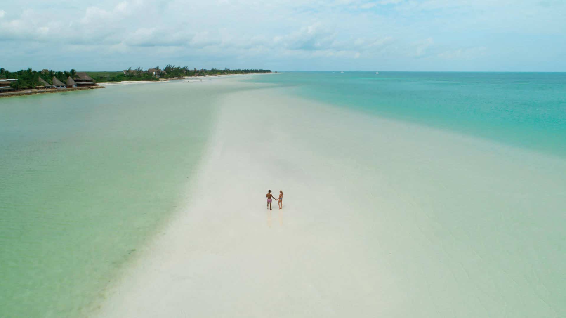 A drone shot couple on a sandbar in gorgeous Isla Holbox in Mexico
