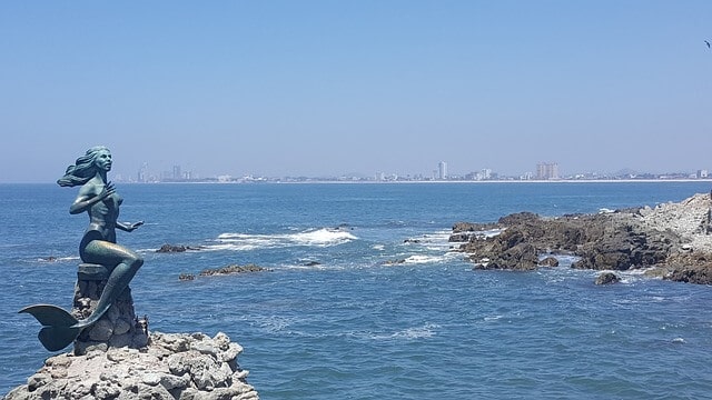 A statue of a mermaid amidst some blue waters in Mazatlan